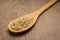 Whole Chinese Rice seed. Spoon and grains over wooden table.