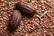 Whole cocoa pods and metal scoop on beans, top