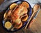 Whole crispy golden roast duck with fresh orange slices for a festive . Top view rustic wooden background