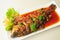 Whole fried fish topped with sweet chili sauce