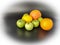 Whole fruits green apples, orange, grapefruit and lemon on black background. Concept - vegetarian and healthy food to improve the