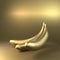 Whole golden banana on gold background