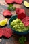 Whole grain beetroot crackers with avocado guacamole dip