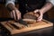 Whole grain bread put on kitchen wood plate with a chef holding gold knife for cut. Fresh bread on table close-up