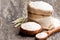 Whole grain flour in a wooden bowl and sackcloth bagwith ears