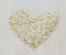 Whole grain oats in heart shape on wooden board