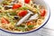 Whole grain pasta with sardines, tomato and arugula. Italian Sicilian cuisine