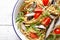 Whole grain pasta with sardines, tomato and arugula. Italian Sicilian cuisine, top view