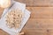 Whole grain wheat raw apulian pasta Pizzarieddi or maccaruni on a cotton napkin board on wooden table. Italian pasta