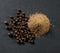 whole and ground black allspice peppercorns close-up on gray background