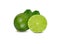Whole and half cut ripe green lime with leaves on white background