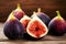 Whole and half ripe purple figs on wooden table close up. Fresh Mediterranean fruits. Eating summer sweet fruit