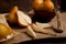 Whole, half and slices of pears and bowl with fruits on wooden background with yellow kitchen towel