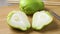 Whole and halved fresh green chayote close up
