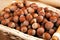 Whole hazelnut kernels in a wicker basket still life