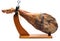 Whole leg of Spanish Iberian serrano ham in wooden support jamoneror.