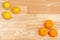 Whole lemons and cut lemons on a wooden table and oranges and cut oranges