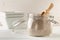 Whole, organic white chia seeds heap in glass storage jar on white table background