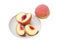 Whole peach and sliced peach on a saucer