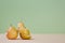 Whole pear and divided on slices. Healthy nutrition. Summer mellow fruit. Diet. Green background. Copy space for text