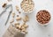 Whole and peeled peanut nuts with cracker and linen bag on light background.Macro