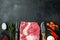 A whole piece of raw Beef Brisket,with ingredients for smoking  making  barbecue, pastrami, cure, on black stone background, top