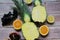 Whole pineapple cut in half, two pieces of pineapple halves, pineapple fruit on wooden background, yellow fruit