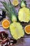 Whole pineapple cut in half, two pieces of pineapple halves, pineapple fruit on wooden background, yellow fruit