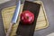 Whole pomegranate fruit on a napkin / cloth on a wooden tray. A large red pomegranate with a knife next to it, ready to be opened