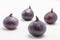 Whole purple figs. White background