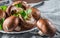 Whole raw fresh brown mushroom portobello on white plate.