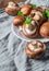 Whole raw fresh brown mushroom portobello on white plate.