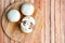 Whole raw fresh cultivated brown mushrooms, also known as champignons, on a wooden cutting board close-up