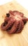 Whole raw octopus on a wooden cutting board