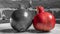 Whole red pomegranate and white and black pomegranate on big white plate. Garnet is a symbol of Judaism