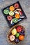 Whole and sliced fruits on rustic wood table - vertical portrait mode