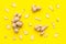 Whole and sliced ginger roots yellow background top view