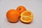 Whole and sliced navel oranges on a seamless background