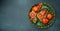 Whole and sliced sicilian oranges on a dark background. Long banner format. top view