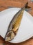 Whole smoked mackerel on a wooden table