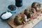 Whole Sweet Marmande tomatoes on wooden board and stone background