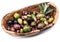 Whole table olives in the wooden bowl.