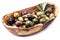 Whole table olives in the wooden bowl.