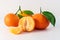 Whole tangerines or mandarines orange fruits and peeled segments