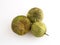 Whole tomatillos on a white cutting board