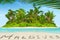 Whole tropical island within atoll in tropical Ocean and inscription \
