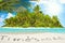 Whole tropical island within atoll in tropical Ocean and inscription \