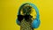 Whole unpeeled pineapple with sunglasses and headphone listening to music