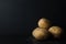 Whole, Unpeeled Potatos on Black with Soil