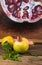 Whole unripe pomegranates with a blurred painting background on